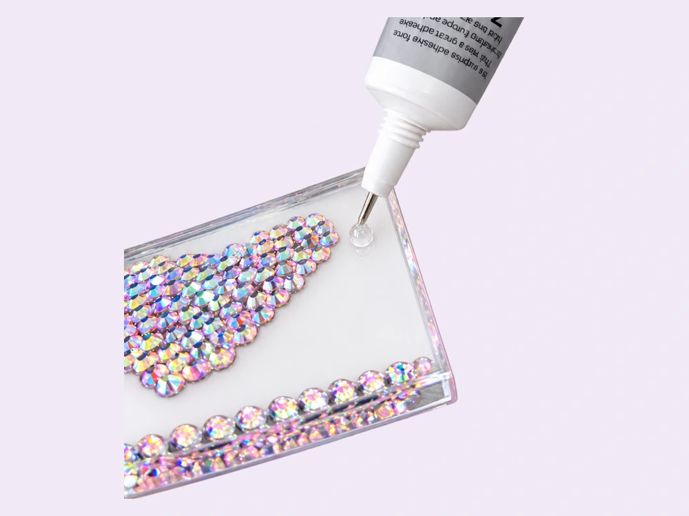 Glue being applied to a clear acrylic board